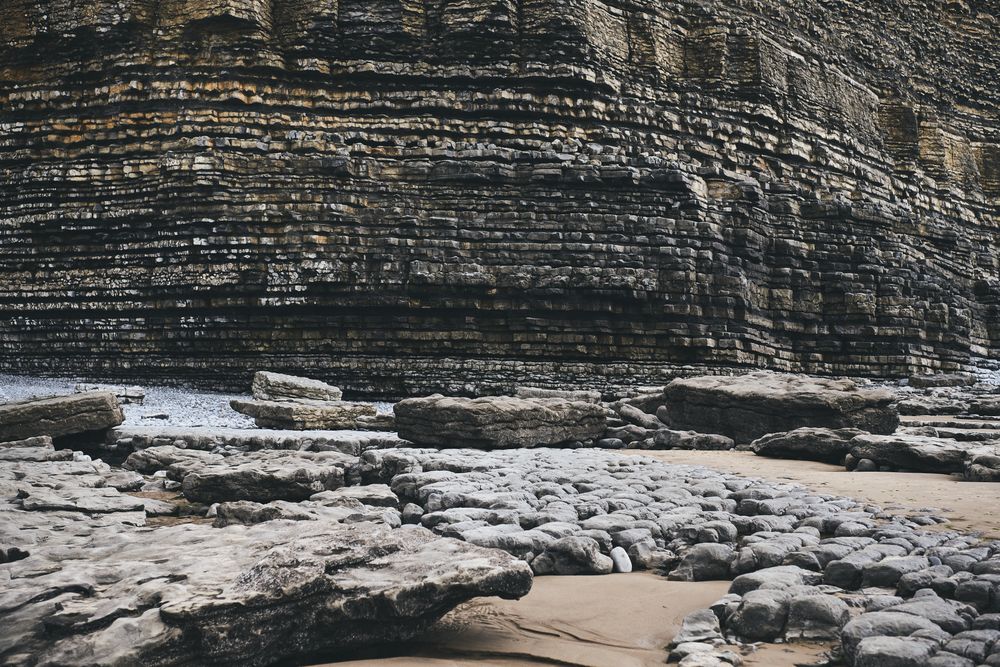 A wall of rocks by a river
