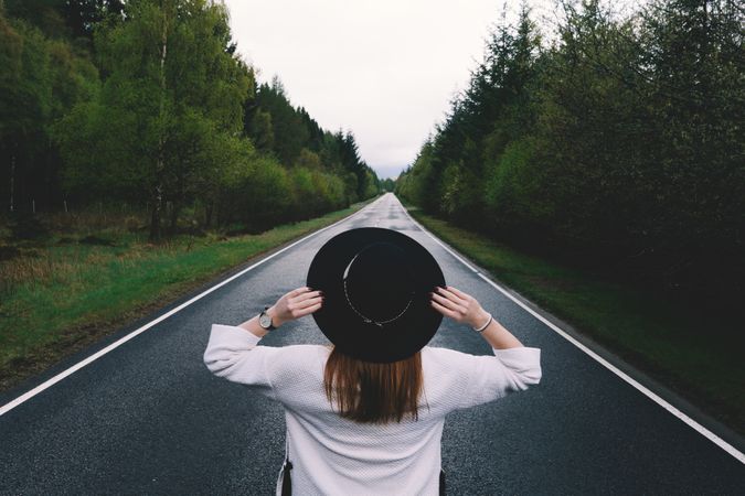 Stylish woman on remote empty road