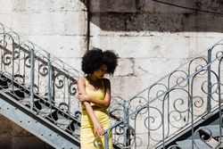 Stylish female leaning on railing outdoors