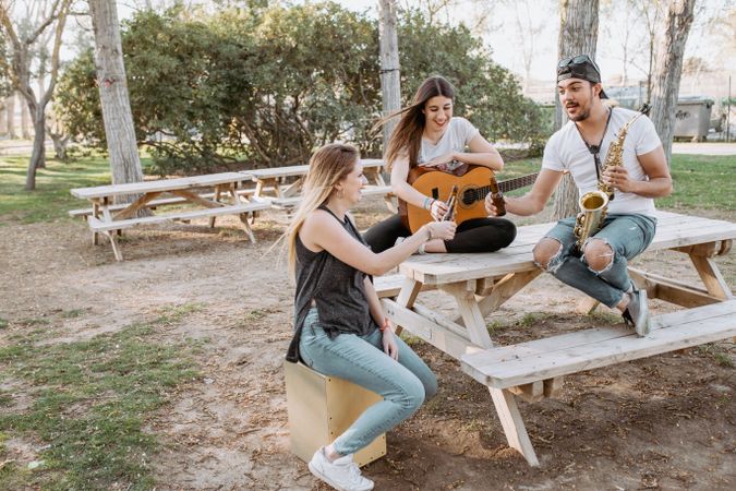 Young musicians drinking beer in park
