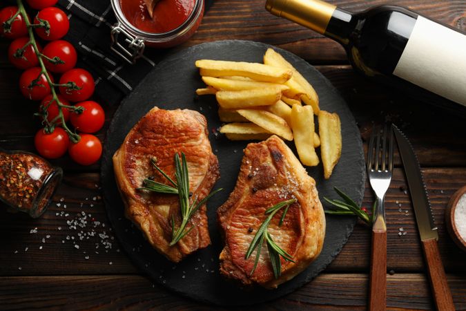 Composition with fried steaks and wine. Grilled food