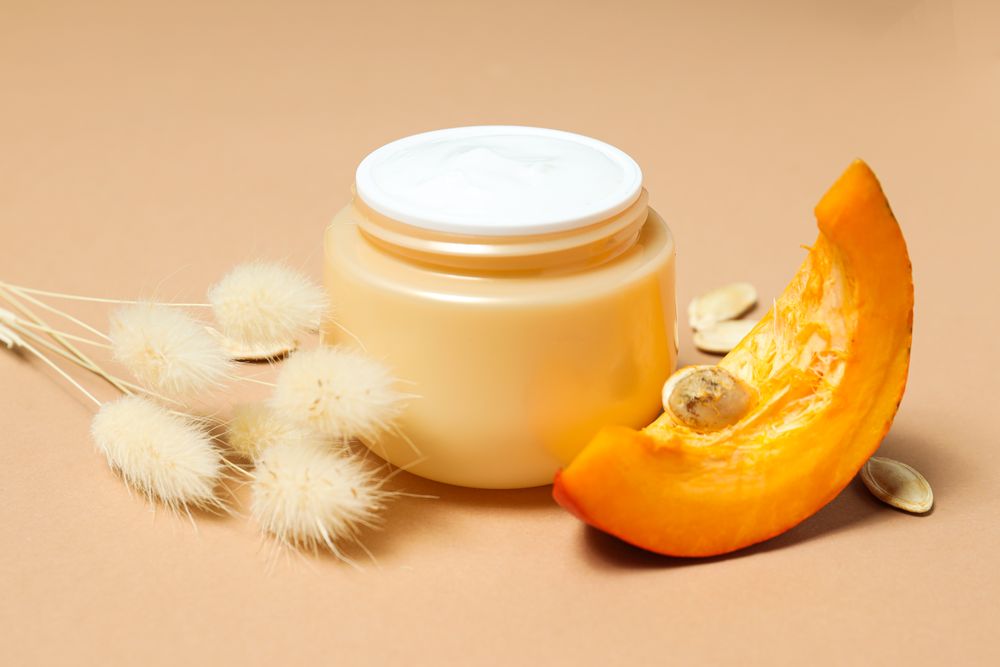 Skin care and face care concept - pumpkin cosmetic