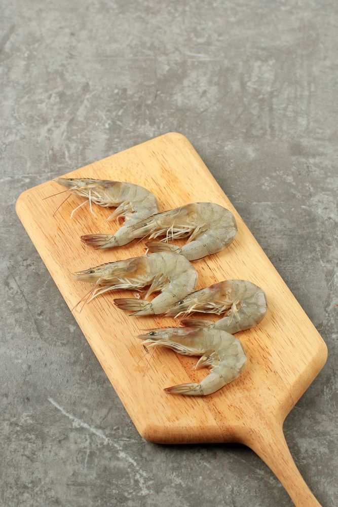 Uncooked prawns on board being prepared before cooking