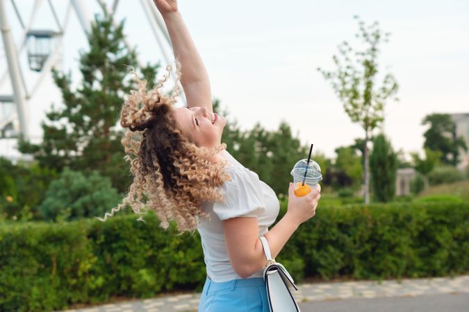 Woman with drink outdoors