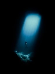 Underwater shot of Person diving in ocean depth