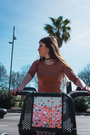 Young woman riding back on scooter