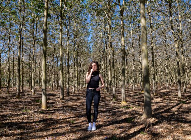 Sporty girl standing in forest