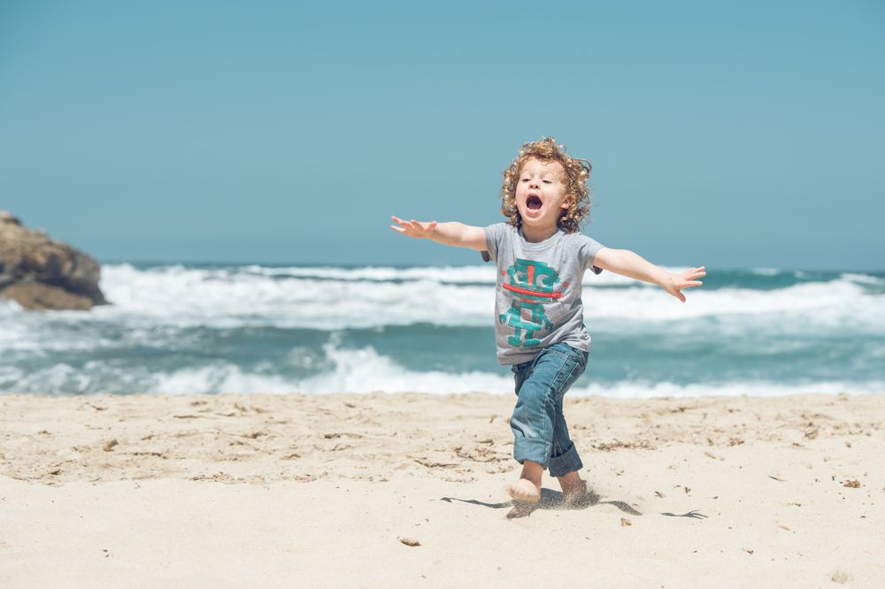 Carefree boy running on beach