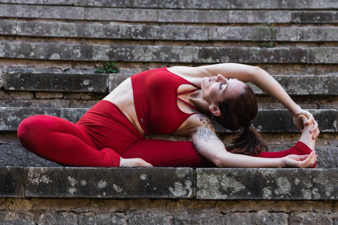 Slim woman doing yoga in Revolved Head to Knee pose