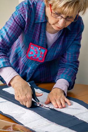 Dressmaker cutting a cloth