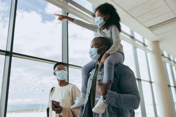 Black family at airport in pandemic