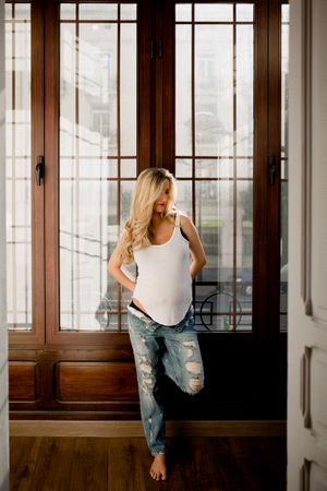 Pregnant woman near open door
