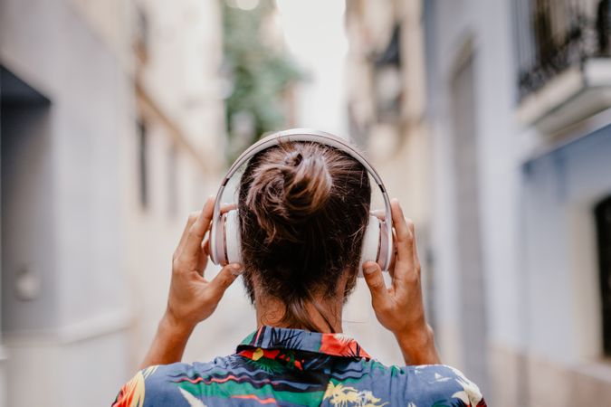 Modern male listening to music on street
