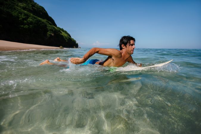 Young man water surfing in ocean
