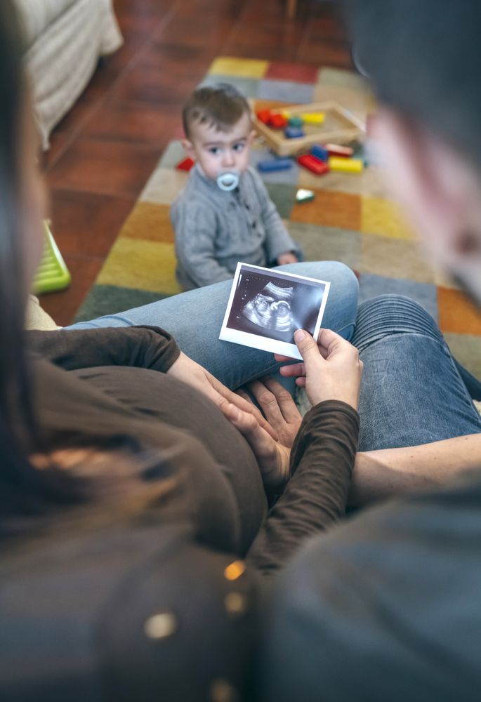 Parents looking at ultrasound of their new baby