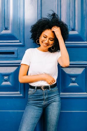 Stylish Black female by blue door