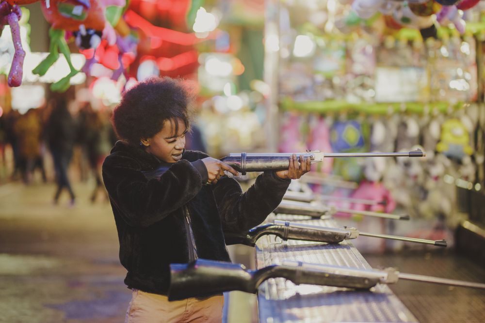 Black woman shooting in amusement park