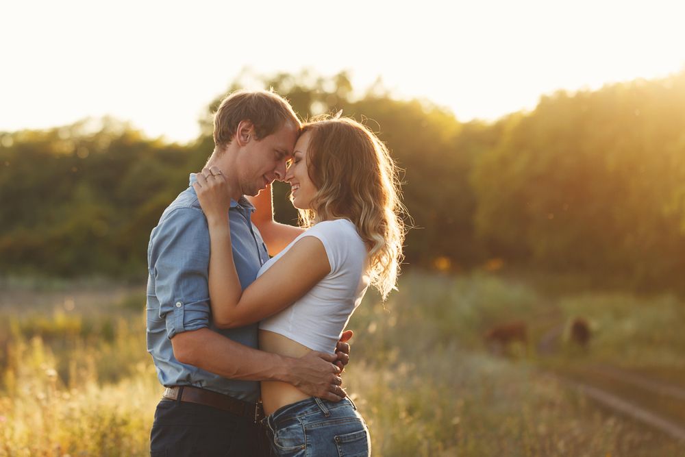 Happy couple embracing at sunset