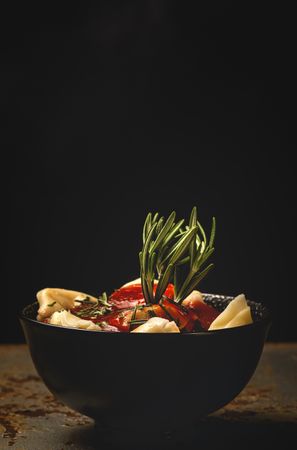 Plate of delicious ravioli with tomato sauce served on table