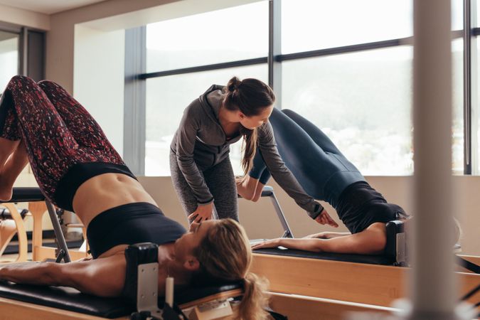 Two fitness women doing pilates training at the pilates gym