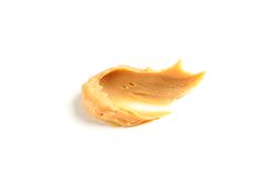 Creamy peanut butter isolated on bright background. A traditional product of American cuisine