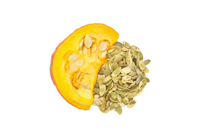 Fall season food - pumpkin seeds, isolated on light background