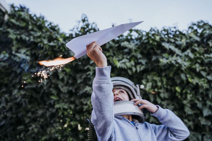 Surprised kid having fun with sparkling airplane