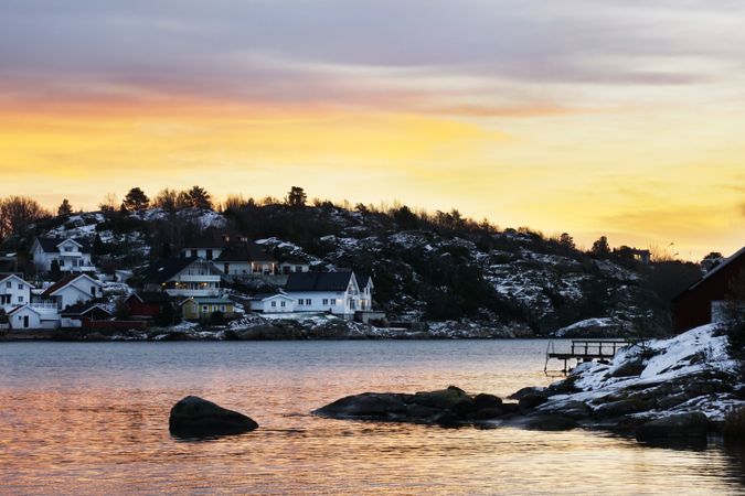 Picturesque view of town on snowy hilly shore