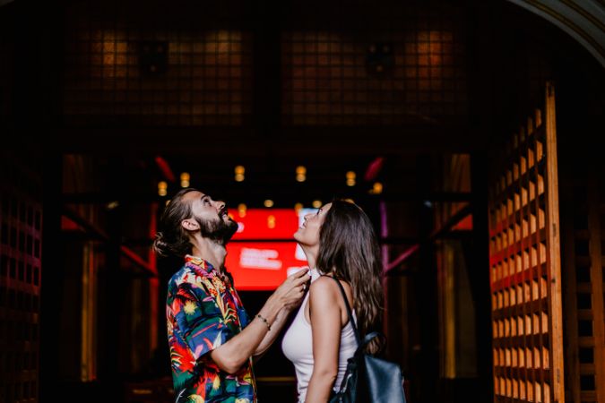 Laughing couple against building entrance