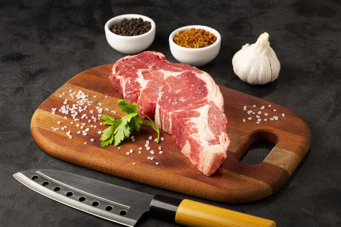 Raw ancho meat ready to roast on a wooden cutting board.
