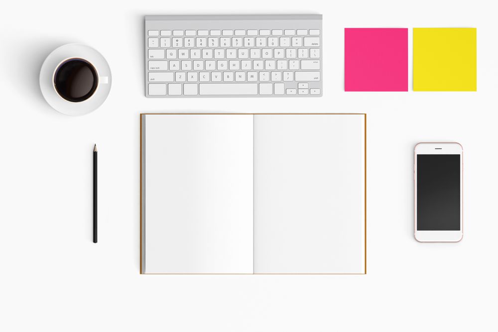 Modern workspace with coffee cup, smartphone, paper, notebook, tablet and laptop