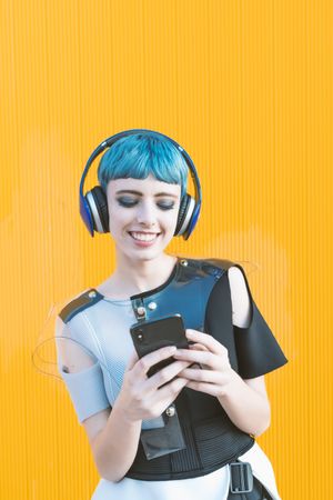 Futuristic woman using smartphone and listening to music