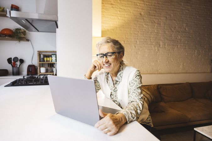 Mature woman using laptop at home