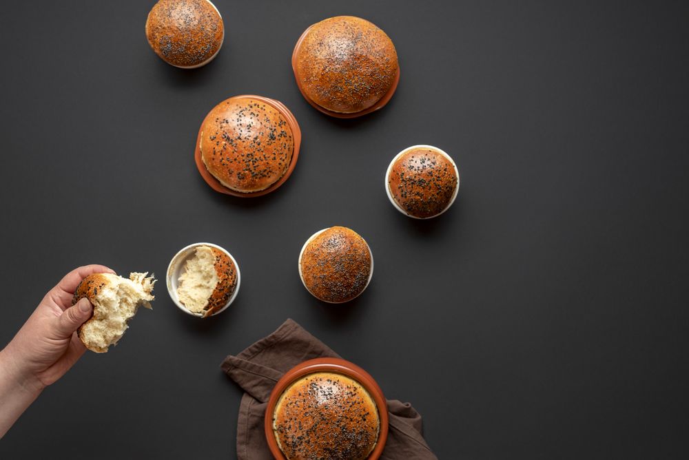 Eating bread buns from a ceramic pots