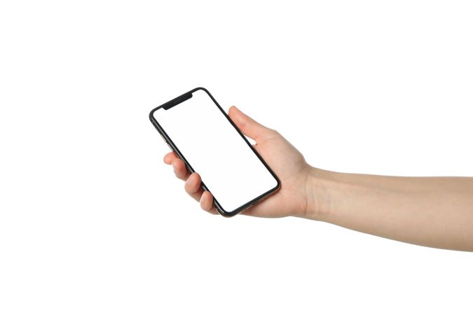 Female hand holding phone with empty screen, isolated on plain background