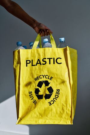 Woman with bright bag with empty plastic bottles