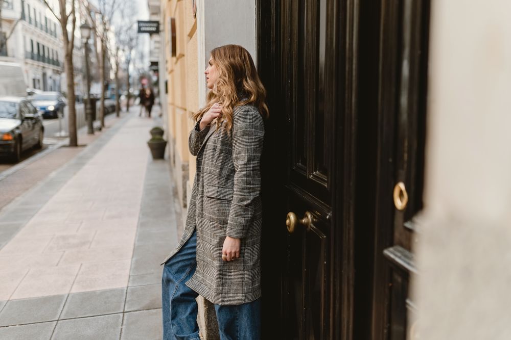 Woman leaning on wall on street