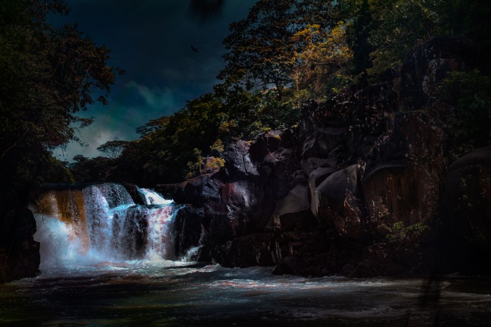 Rocky waterfall under evening sky