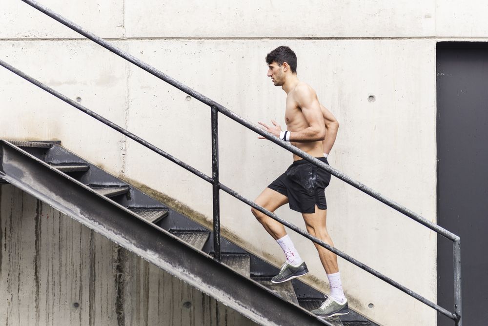 Man training and going up on steps