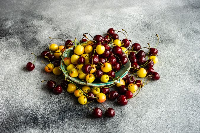 Dark & yellow cherries on plate on kitchen counter