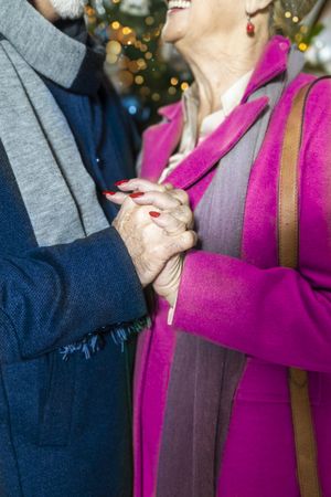 Close up of mature couple holding hands and smiling