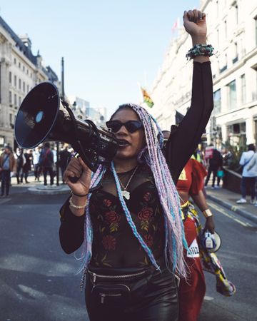 London, England, United Kingdom - March 19 2022: Black woman with loudspeaker and raised fist