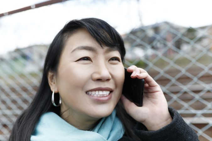 Smiling woman having a phone call outdoor