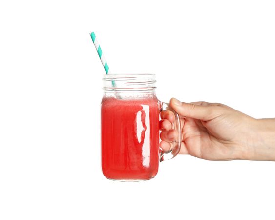Female hand hold glass jar of watermelon juice, isolated on blank background