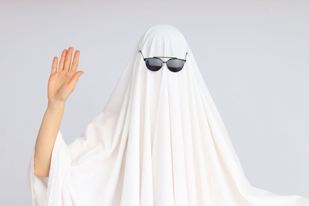 Concept of Halloween, Ghost with sunglasses on light background
