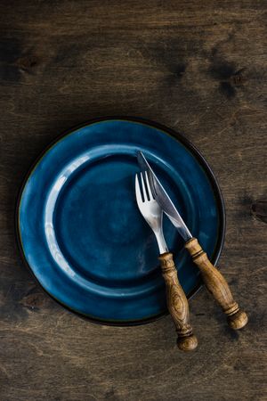 Rustic table setting with navy plate and cutlery