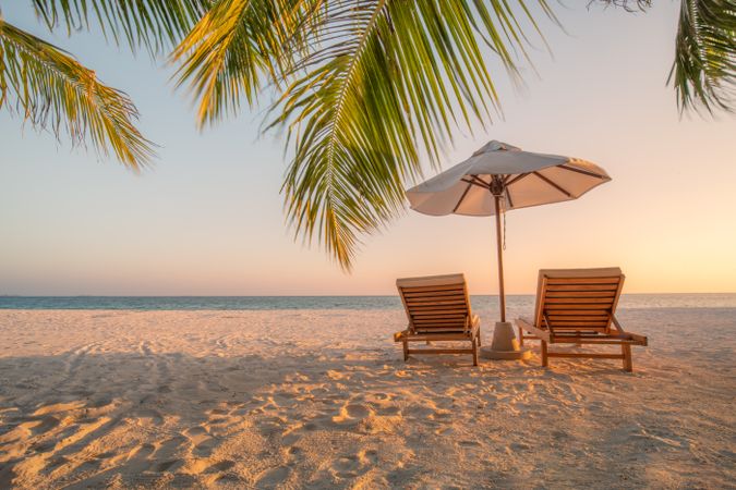 Two lounge chairs on an idyllic tropic beach, landscape