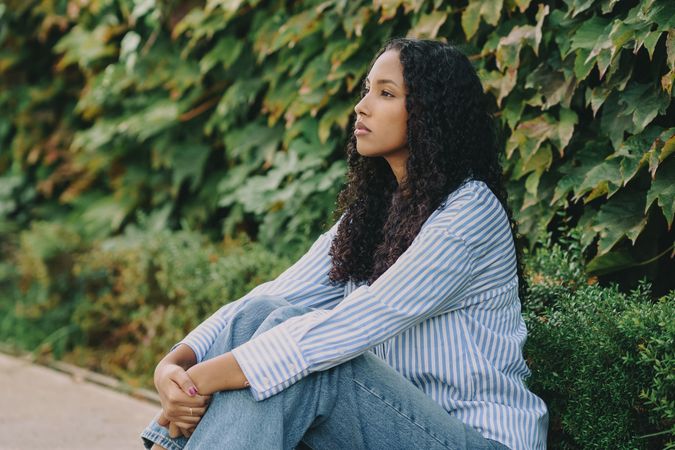 A Thoughtful Young Woman Enjoying Natures Beauty and Serenity Surrounded by Greenery