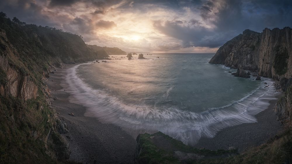 Beautiful bay around rocks and cloudy sunset