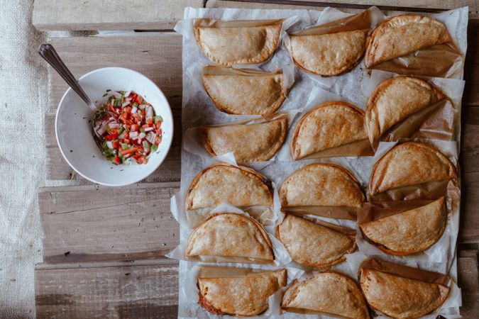 Baking tray with composed freshly baked pies patty